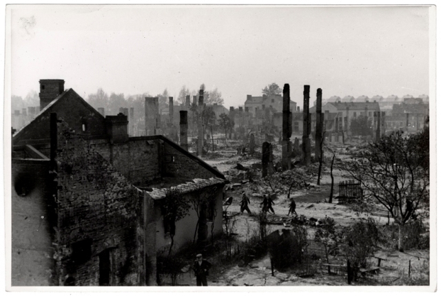 Poles walk among the ruins of besieged Warsaw, 1939 - USHMM